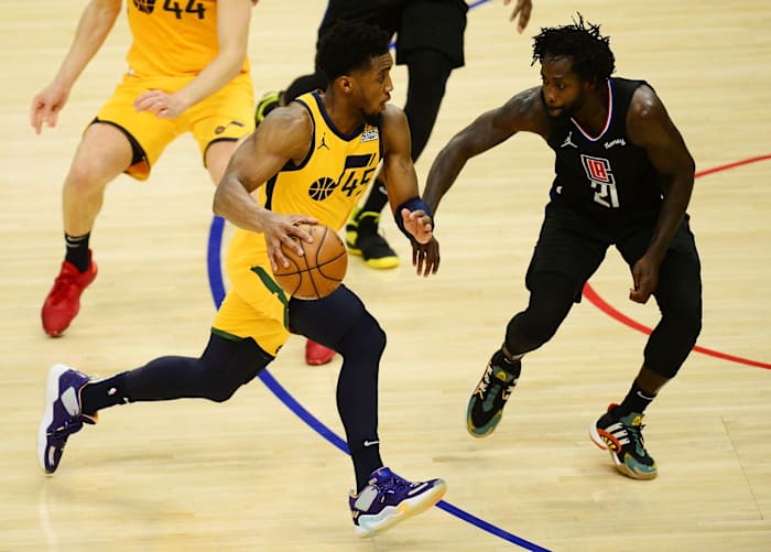 Donovan Mitchell (45) drives past Patrick Beverley (21)